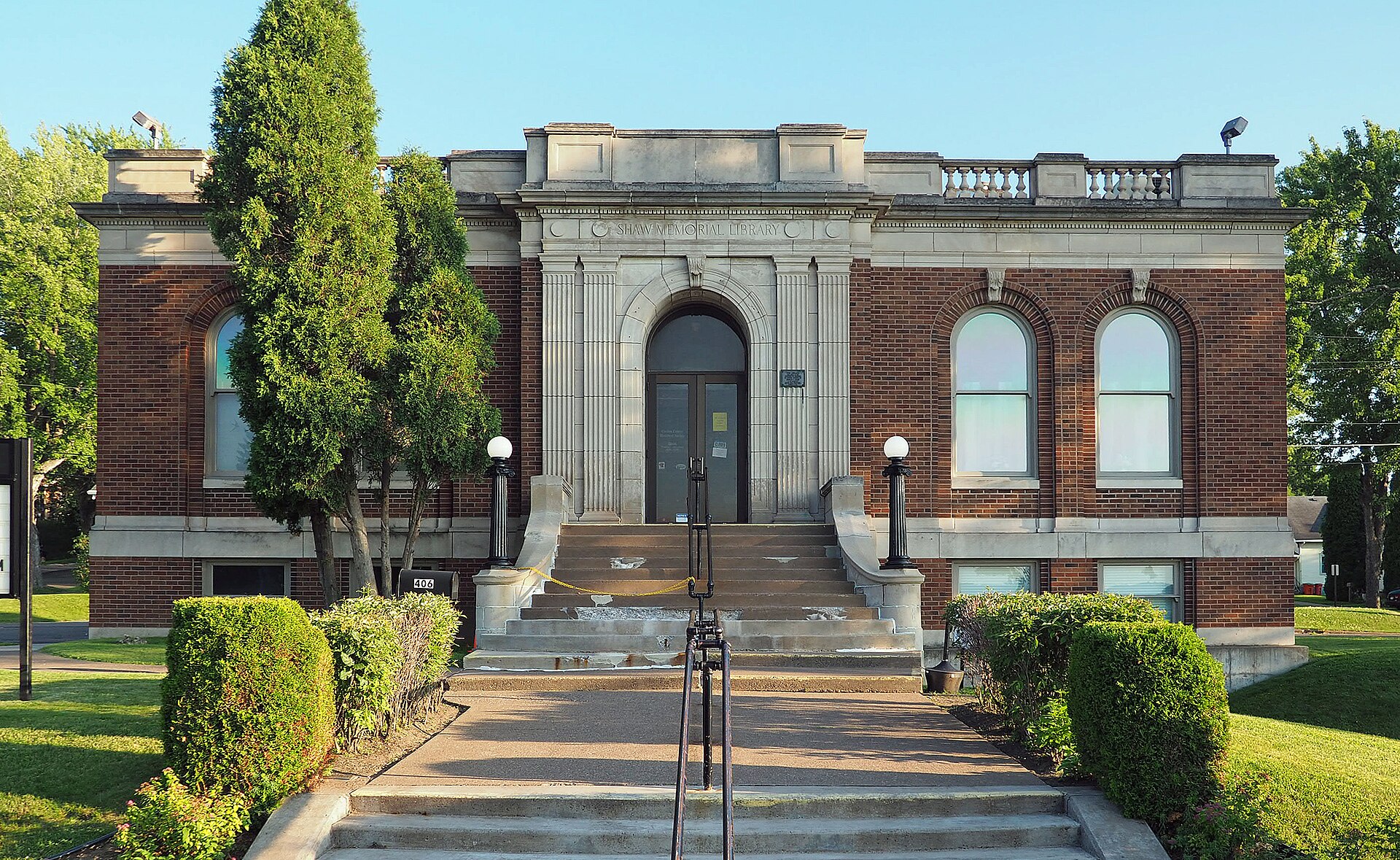 The brick and limestone Shaw Memorial Library at 406 Cloquet Avenue in Cloquet, Minnesota