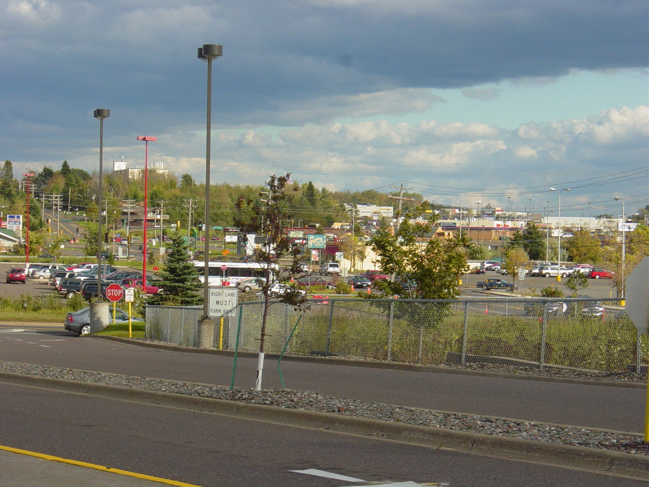 The Miller Trunk Highway retail corridor in Duluth Heights, with parking lots, big box stores and a wooded ridge behind