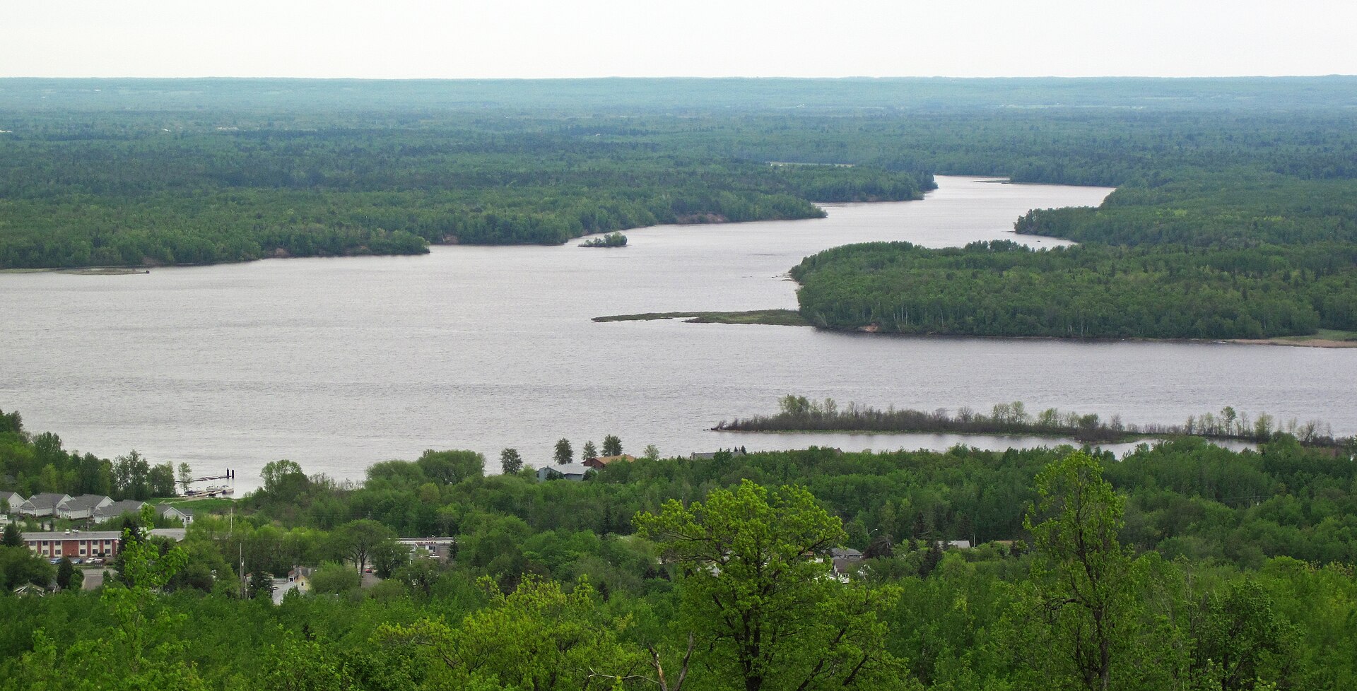 The St. Louis River winding through unbroken forest below the Duluth hilltop, seen from a high overlook