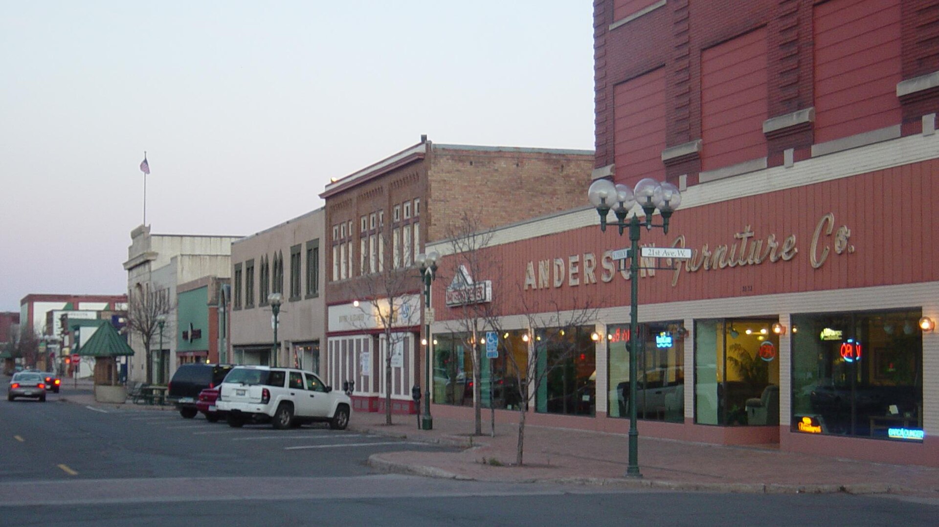 A block of two and three story brick and stone storefronts along West Superior Street at 21st Avenue West in Duluth