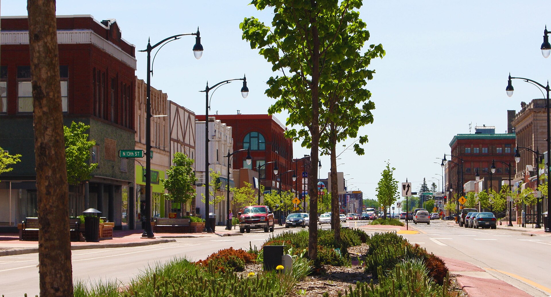 Tower Avenue in downtown Superior, Wisconsin, with a planted median, period street lamps and 1890s brick commercial blocks